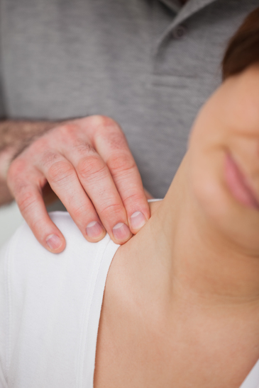 Close-up of a man massaging the nape of a woman in a room